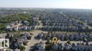 Aerial perspective showcasing a residential area with a mix of single-family homes and mature trees - 1206 Mckinney Court, Edmonton, AB  - Outdoor With View 