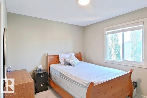 Bright room featuring a single window with blinds, neutral wall paint, and overhead lighting - 1206 Mckinney Court, Edmonton, AB - Indoor Photo Showing Bedroom