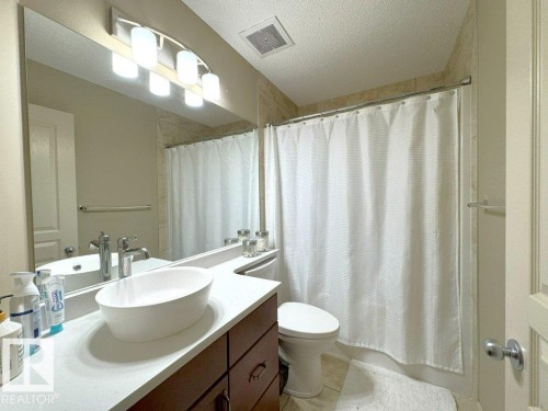 Contemporary vanity featuring a vessel sink, single-handle faucet, and white countertop - 1206 Mckinney Court, Edmonton, AB - Indoor Photo Showing Bathroom