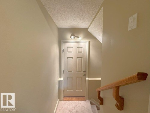 Entryway featuring a paneled door, integrated overhead lighting, and a neutral color palette - 1206 Mckinney Court, Edmonton, AB - Indoor Photo Showing Other Room