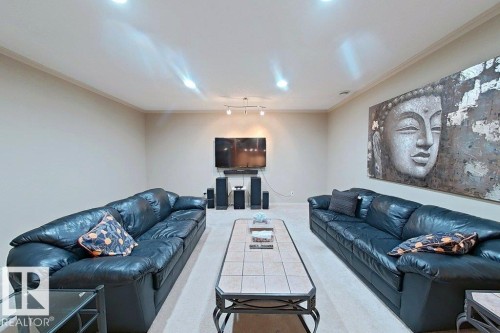Spacious living area featuring light-toned walls, recessed lighting, and crown molding - 1206 Mckinney Court, Edmonton, AB - Indoor