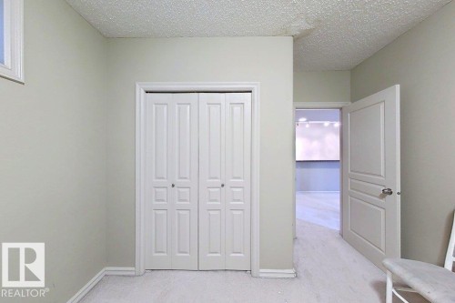 Neutral wall tones, white baseboards, and bi-fold closet doors - 1206 Mckinney Court, Edmonton, AB - Indoor