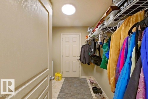 Entryway featuring a skylight, paneled door, tiled flooring, and wire shelving system - 1206 Mckinney Court, Edmonton, AB - Indoor With Storage