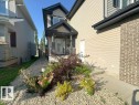 Property exterior featuring a covered front entry with dark columns and a glass-paneled door - 1206 Mckinney Court, Edmonton, AB  - Outdoor 