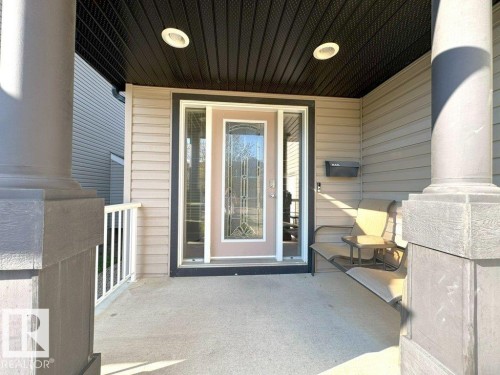 Inviting covered front porch with recessed lighting - 1206 Mckinney Court, Edmonton, AB - Outdoor With Deck Patio Veranda With Exterior
