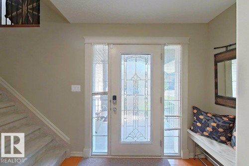 Entryway featuring a decorative glass panel door with sidelights, a modern smart lock, and neutral wall paint - 1206 Mckinney Court, Edmonton, AB - Indoor Photo Showing Other Room