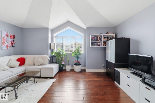 Living room featuring hardwood floors and an arched window - 3243 26 Street, Edmonton, AB - Indoor Photo Showing Living Room