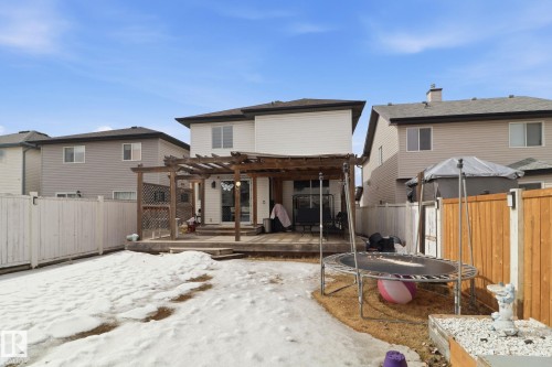 The property features a backyard with a wooden deck and pergola, and a privacy fence - 3243 26 Street, Edmonton, AB - Outdoor