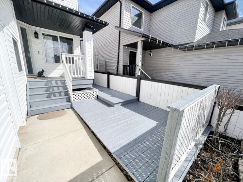 The property features a front deck with a ramp and steps, a white railing, and a lattice detail - 3243 26 Street, Edmonton, AB - Outdoor With Deck Patio Veranda With Exterior