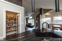 Granite countertop with integrated black sink and matte black gooseneck faucet - 
