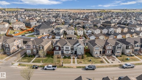 Aerial perspective of a developed residential area featuring multiple single-family homes with diverse architectural styles, asphalt shingle roofs, and paved driveways - 8131 Chappelle Way, Edmonton, AB - Outdoor With View