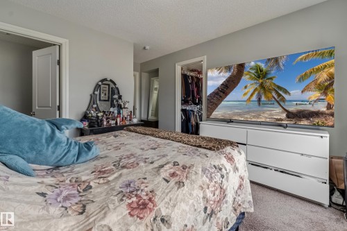 Light gray wall paint, textured ceiling, and carpet flooring - 8131 Chappelle Way, Edmonton, AB - Indoor Photo Showing Bedroom