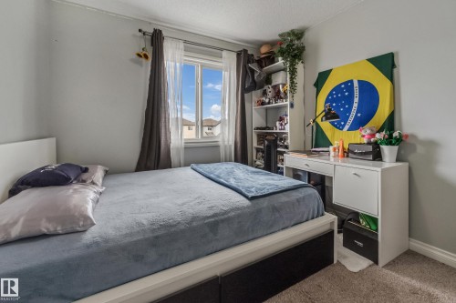 Bedroom featuring a large window, neutral wall paint, and carpet flooring - 8131 Chappelle Way, Edmonton, AB - Indoor Photo Showing Bedroom