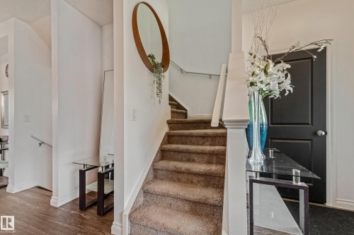 Carpeted staircase with white balustrade and handrail - 8131 Chappelle Way, Edmonton, AB - Indoor Photo Showing Other Room
