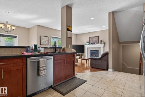 9 Woodbridge Link, Fort Saskatchewan, AB - Indoor Photo Showing Kitchen With Fireplace