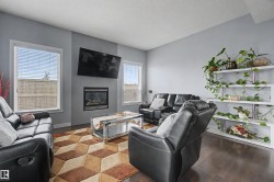Living area featuring dark wood-finish flooring and light gray walls - 