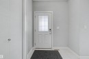 Entryway featuring a white door with frosted glass panels, light gray wall paint, white trim, and light-colored tile flooring - 1602 Chapman Way, Edmonton, AB  - Indoor Photo Showing Other Room 