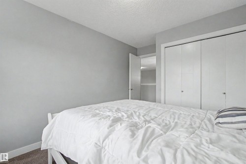 Bedroom featuring light gray walls, white baseboards, and carpeted flooring - 1602 Chapman Way, Edmonton, AB - Indoor Photo Showing Bedroom