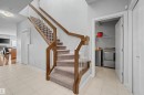 Staircase with wood-finish handrails and carpeted treads - 1602 Chapman Way, Edmonton, AB  - Indoor Photo Showing Other Room 