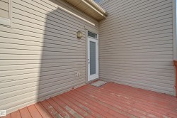 Outdoor deck with red-stained wood flooring - 