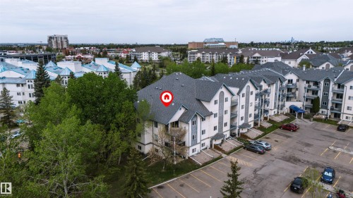 Multi-story residential complex featuring light-colored siding, peaked roofs, and individual balconies - 302 2508 50 Street Nw, Edmonton, AB - Outdoor