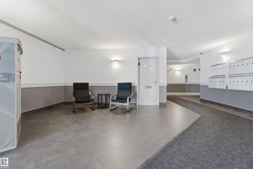 Entryway featuring mailboxes, parcel lockers, and a combination of carpeted and tiled flooring - 302 2508 50 Street Nw, Edmonton, AB - Indoor Photo Showing Other Room