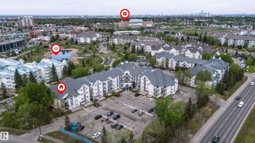 Multi-story residential complex featuring private balconies and an on-site parking lot - 302 2508 50 Street Nw, Edmonton, AB - Outdoor With View