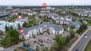 Multi-story residential complex featuring private balconies and an on-site parking lot - 302 2508 50 Street Nw, Edmonton, AB  - Outdoor With View 