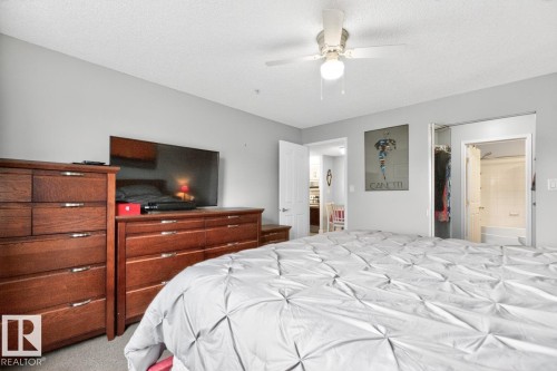 Bedroom featuring light grey walls and a textured ceiling - 220 16303 95 Street, Edmonton, AB - Indoor Photo Showing Bedroom
