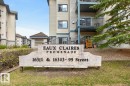 Eaux Claires Promenade entrance sign featuring embossed lettering, a stone-finish texture, and a metal bench - 220 16303 95 Street, Edmonton, AB  - Outdoor With Balcony 