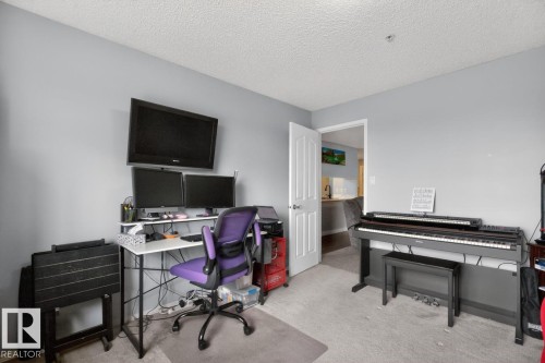 Interior room featuring neutral wall paint, textured ceiling, and carpeting - 220 16303 95 Street, Edmonton, AB - Indoor Photo Showing Office