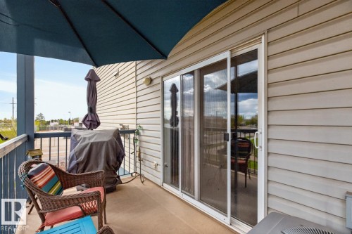 Private balcony featuring a concrete floor and a sliding glass door - 220 16303 95 Street, Edmonton, AB - Outdoor With Deck Patio Veranda With Exterior