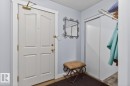 Entryway with panel door, brass hardware, and wood-finish flooring - 220 16303 95 Street, Edmonton, AB  - Indoor Photo Showing Other Room 