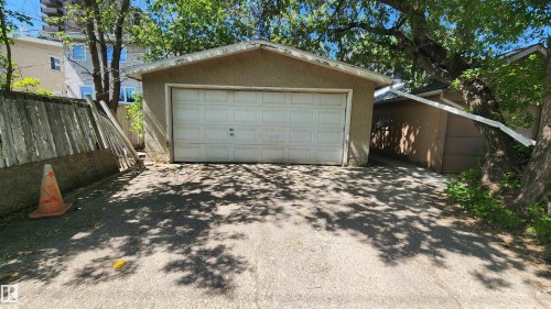 Detached garage featuring a white panel door and stucco exterior - 4709 106 Street, Edmonton, AB - Outdoor