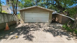 Detached garage featuring a white panel door and stucco exterior - 
