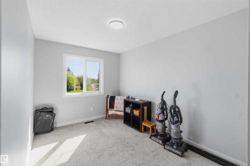 Room with light gray walls, white trim, and a window overlooking greenery - 5129 Lark Crescent, Edmonton, AB - Indoor