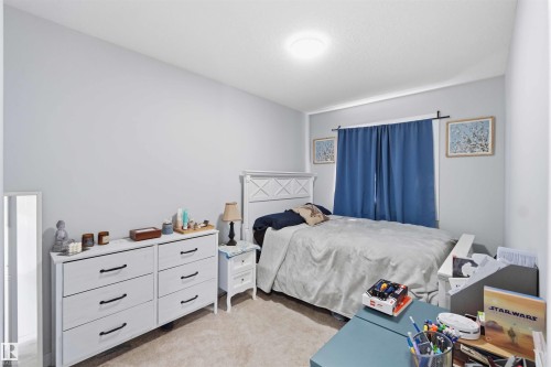 Carpeted room with light gray walls and a flush-mount ceiling light fixture - 5129 Lark Crescent, Edmonton, AB - Indoor Photo Showing Bedroom