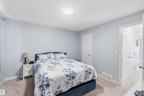 Spacious room featuring light blue walls and neutral carpet flooring - 5129 Lark Crescent, Edmonton, AB - Indoor Photo Showing Bedroom