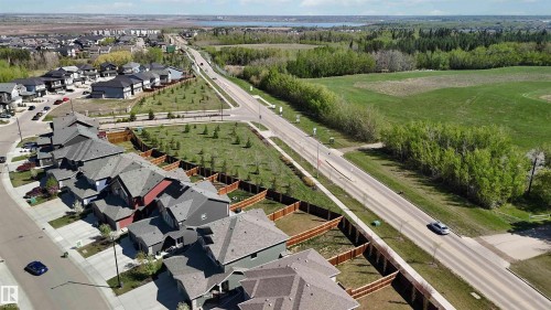 Aerial perspective highlighting a residential development bordered by open green spaces and wooded areas - 5129 Lark Crescent, Edmonton, AB - Outdoor With View