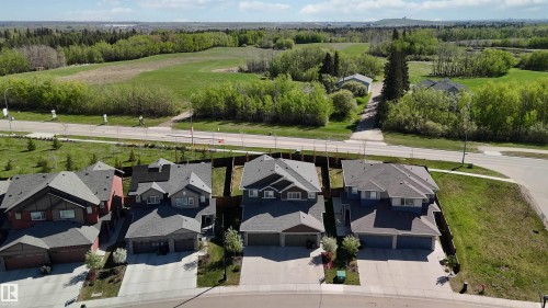 Residential property featuring an asphalt shingle roof, attached garage, and concrete driveway - 5129 Lark Crescent, Edmonton, AB - Outdoor With Facade