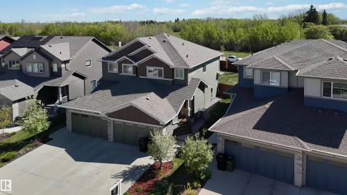 Two-story residence featuring a multi-gable roofline, attached two-car garage, and a concrete driveway - 5129 Lark Crescent, Edmonton, AB - Outdoor With Facade