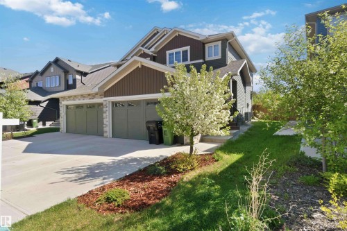 Contemporary multi-level residence featuring a multi-toned exterior with stone accents and horizontal siding - 5129 Lark Crescent, Edmonton, AB - Outdoor