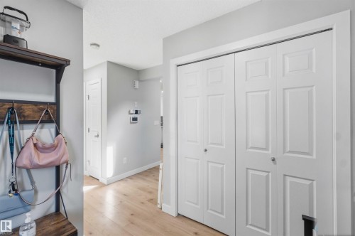 Entryway featuring light wood-finish flooring and a white paneled bi-fold door closet - 5129 Lark Crescent, Edmonton, AB - Indoor Photo Showing Other Room