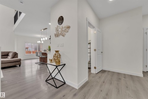 Open-concept living space featuring wood-finish flooring, white baseboards, and neutral wall tones - 22534 98A Avenue, Edmonton, AB - Indoor Photo Showing Other Room