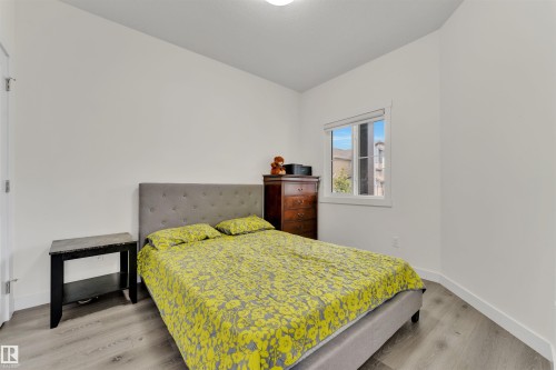 Bedroom featuring light wood-finish flooring, white walls, and a window with white trim - 22534 98A Avenue, Edmonton, AB - Indoor Photo Showing Bedroom