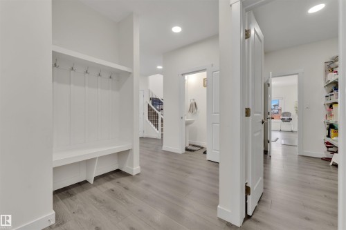 Entryway featuring a built-in bench with storage, integrated coat hooks, and wood-finish flooring - 22534 98A Avenue, Edmonton, AB - Indoor Photo Showing Other Room