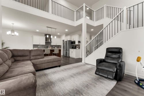 Open-concept living area featuring high ceilings and wood-finish flooring - 22534 98A Avenue, Edmonton, AB - Indoor Photo Showing Living Room