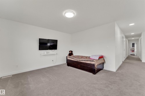 Spacious room with light gray carpeting, crisp white walls, and a recessed ceiling light fixture - 22534 98A Avenue, Edmonton, AB - Indoor