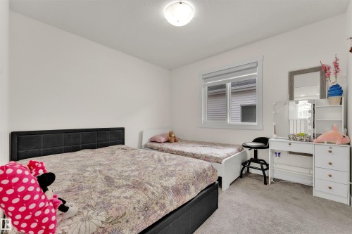 Bedroom featuring light gray carpet flooring, a window with white trim, and a flush mount ceiling light fixture - 22534 98A Avenue, Edmonton, AB - Indoor Photo Showing Bedroom