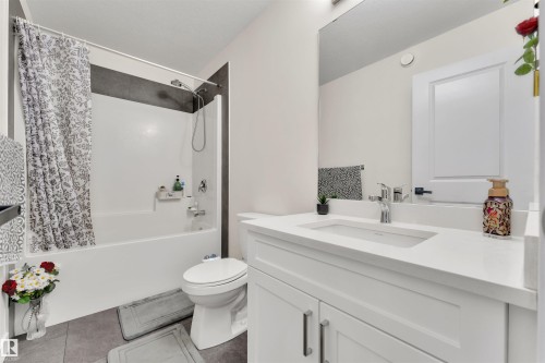 Bathroom featuring a white vanity with integrated sink, chrome faucet, and expansive wall mirror - 22534 98A Avenue, Edmonton, AB - Indoor Photo Showing Bathroom